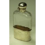 An Edwardian silver and clear glass hip flask,