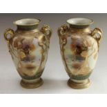 A pair of Noritake ovoid two handled vases, decorated with shield shped cartouches iwth cattle,