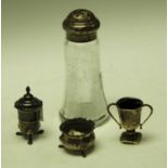 A silver and glass sugar caster; a silver pepper pot; a silver open salt,