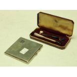 A silver cigarette case, Birmingham 1932; a Dunhill white spot silver cigarette holder part set,