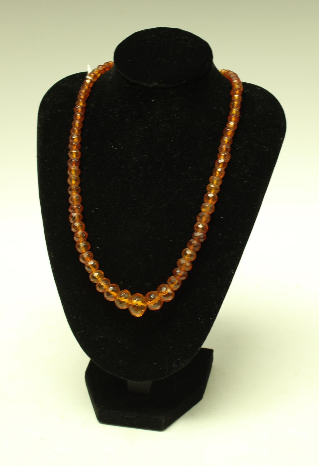 A 19th century faceted amberoid bead necklace,