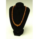 A 19th century faceted amberoid bead necklace,