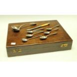 A Russian silver spoon; George III silver teaspoons; an oak canteen box; table knives;