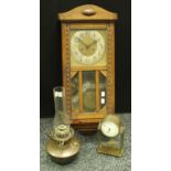 An early 20th century oak cased wall clock,