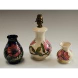 A Moorcroft Magnolia pattern table lamp, 16cm; a Magnolia pattern minature vase,