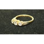 An 18ct gold three stone diamond ring, 2.