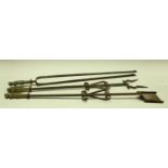 A set of three Baroque steel and brass fire irons, comprising tongs, shovel and poker,