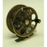 Angling - an early 20th century brass fly fishing reel, twin Bakelite-type rounded handles,