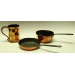 A George III copper saucepan with rolled edge and steel handle,