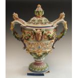 A large Italian two handled centrepiece in relief with ram's masks and fruit swags, caryaid handles,