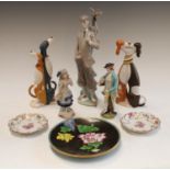 A Lladro model of a golfer, 31cm; a pair of Border Fine Arts Hot Dogs models,