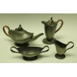 A Liberty Tudric Pewter Arts and Crafts period four-piece tea service, comprising teapot, water jug,