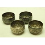 A set of four Indian silver bowls embossed and chased with stylized birds and flowering stems