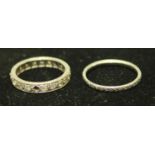 An unmarked white metal diamond eternity ring, probably platinum, 2.7g; a platinum wedding band, 2.