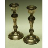 A pair of contemporary silver table candlesticks,