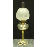 A Victorian brass column oil lamp, pierced domed brass base, clear glass reservoir,