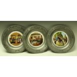 A set of three novelty pewter plates,