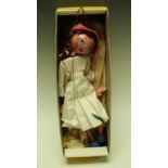 A Pelham puppet, Girl, pink hat, blue eyes, white dress with flash of green,