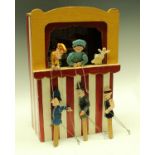 A novelty Punch and Judy theatre, with six wooden puppets,