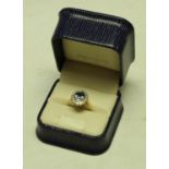 An 18ct gold dress ring, central faceted blue stone surrounded by sixteen diamonds, 4.