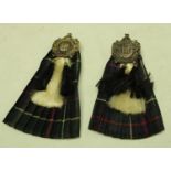 A Scottish Kings Own Borders enamel badge on miniature kilt and sporran;