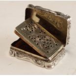 A Victorian silver shaped rectangular viniagrette, vacant cartouche and suspension ring,