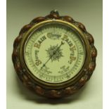 An Edwardian oak framed aneroid barometer