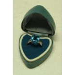A 9ct white gold ring, set with a faceted blue stone, accented with diamond chips, 3.