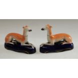 A pair of 19th century Staffordshire greyhound pen rests,