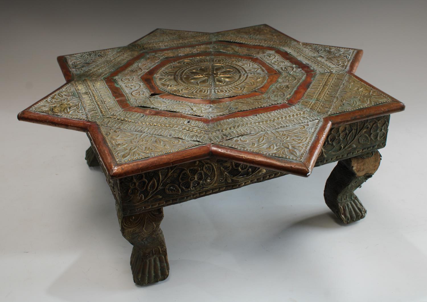 An Indian embossed metal mounted Bajot/opium tea table, 18cm high, 50cm wide,