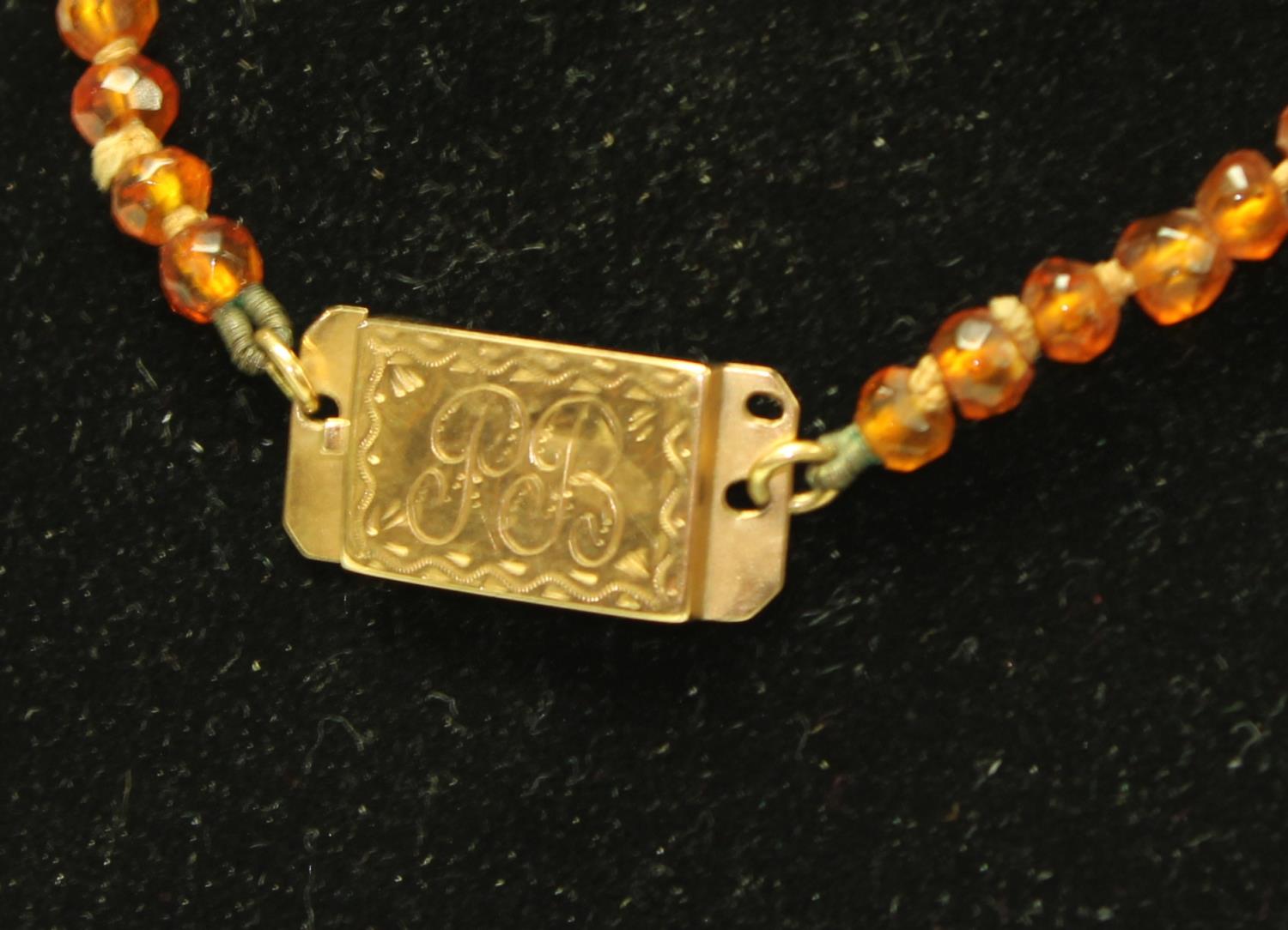 A 19th century faceted amberoid bead necklace, - Image 2 of 2
