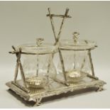 A late Victorian silver plate duo pickle stand with conforming serving spoons terminating in
