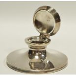 A silver capstan inkwell, hinged cover, rubbed marks,