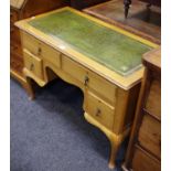 A reproduction writing desk leather inlaid top 73cm high x 107cm wide x 51cm deep