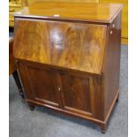 A mahogany bureau, fall front enclosing Formica lined interior over two drawer cupboard.