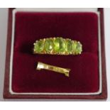 A 9ct gold and five stone ring, claw set with five graduated oval citrines, pierced sides,