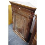 A George III splay fronted oak corner cabinet,