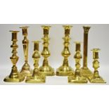 A pair of George III brass candlesticks;