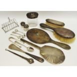 A silver six section toast rack; silver sugar tongs; a George III silver teaspoon;