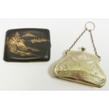 A brass & niello rounded cigarette case decorated with Mount Fufi and village scene,