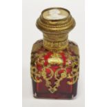 A 19th century continental square cranberry glass scent bottle, stopper, gilt metal overlay,