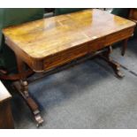 A rosewood library table, crossbanded top, two drawers to frieze, shaped end supports,