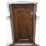 A George III oak corner cupboard c.