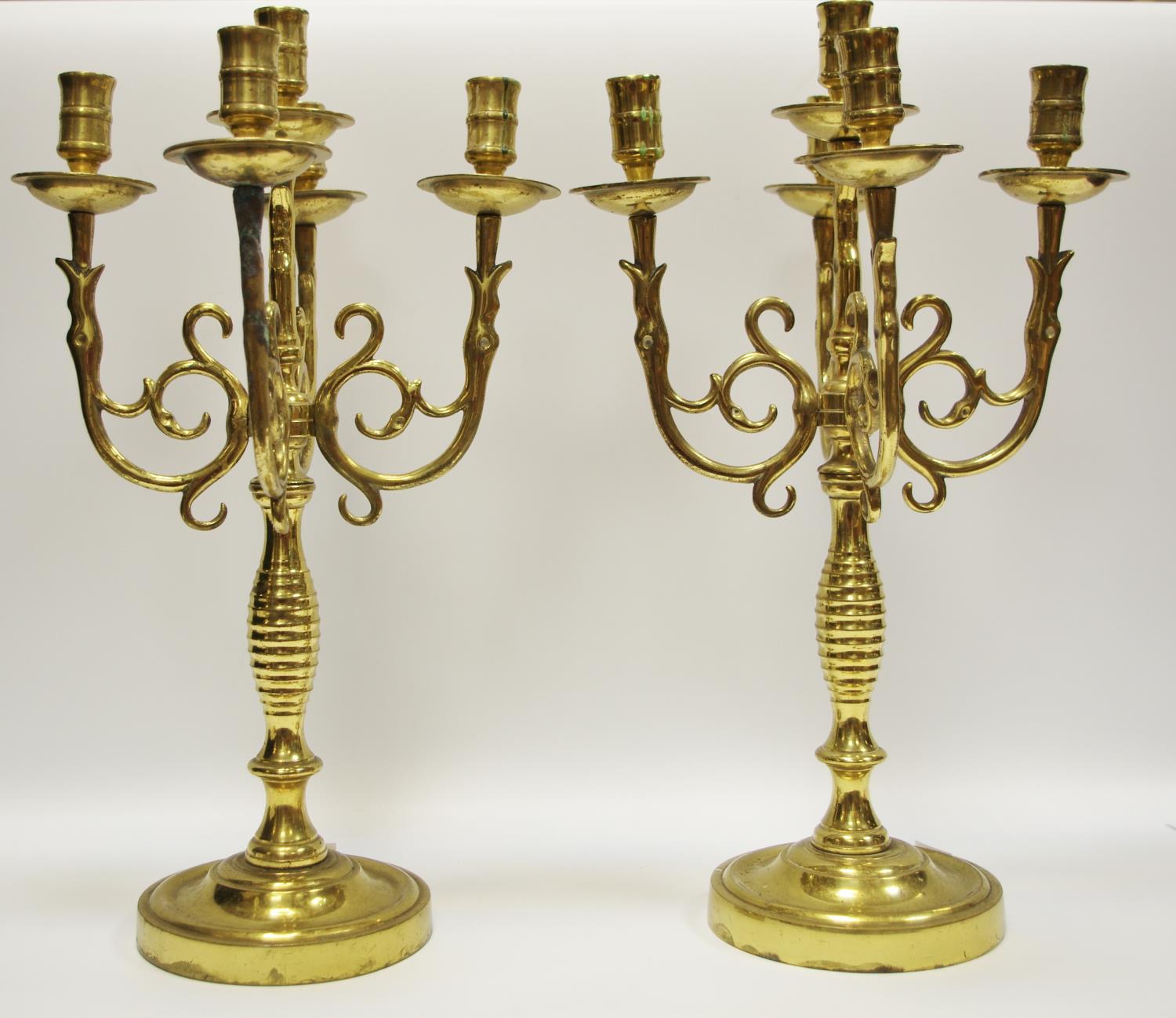 A pair of brass Louis XIII Style candelabrums with 4 branches designed as stylized bird’s heads.