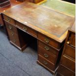 A late Victorian mahogany kneehole desk, leather inlaid top.