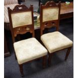 A pair of late Victorian mahogany hall chairs carved top rail, padded back and seat,