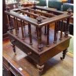 A rosewood Canterbury, turned finials and columns, single drawer to base, turned legs,