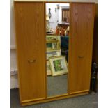 A G-plan triple wardrobe with central mirrored door,