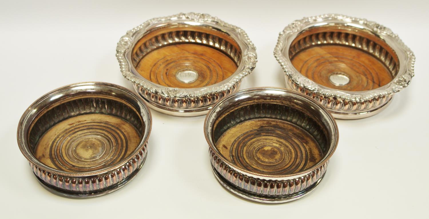 Two pairs of 19th century Sheffield plate wine coasters with wooden inset bases