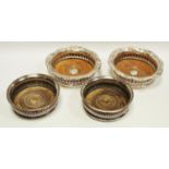 Two pairs of 19th century Sheffield plate wine coasters with wooden inset bases